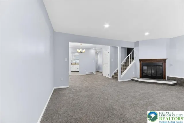 a view of an empty room with a fireplace