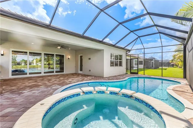 a swimming pool with outdoor seating