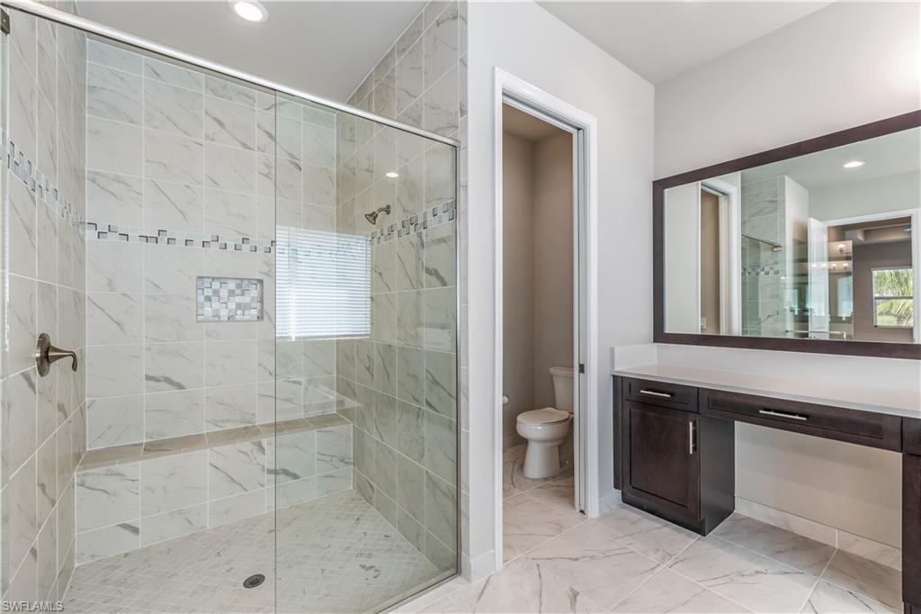 11847 Hydrangea Place Naples, FL 34120 - Photo 21 of 30 a bathroom with a shower and a sink