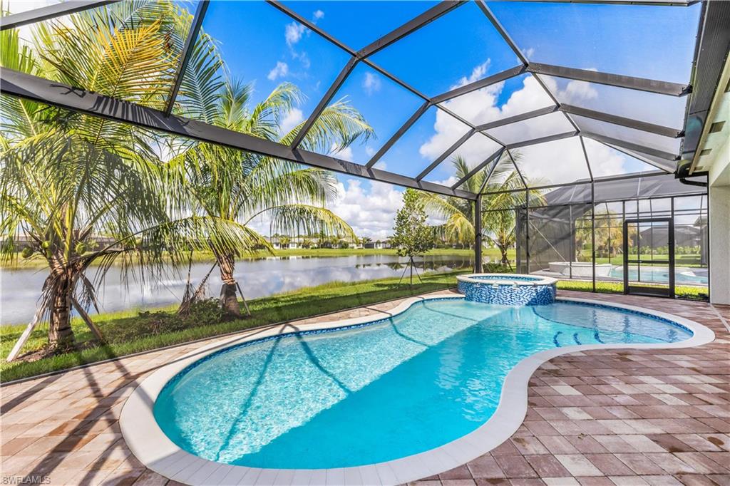 11847 Hydrangea Place Naples, FL 34120 - Photo 4 of 30 a view of a swimming pool with a yard