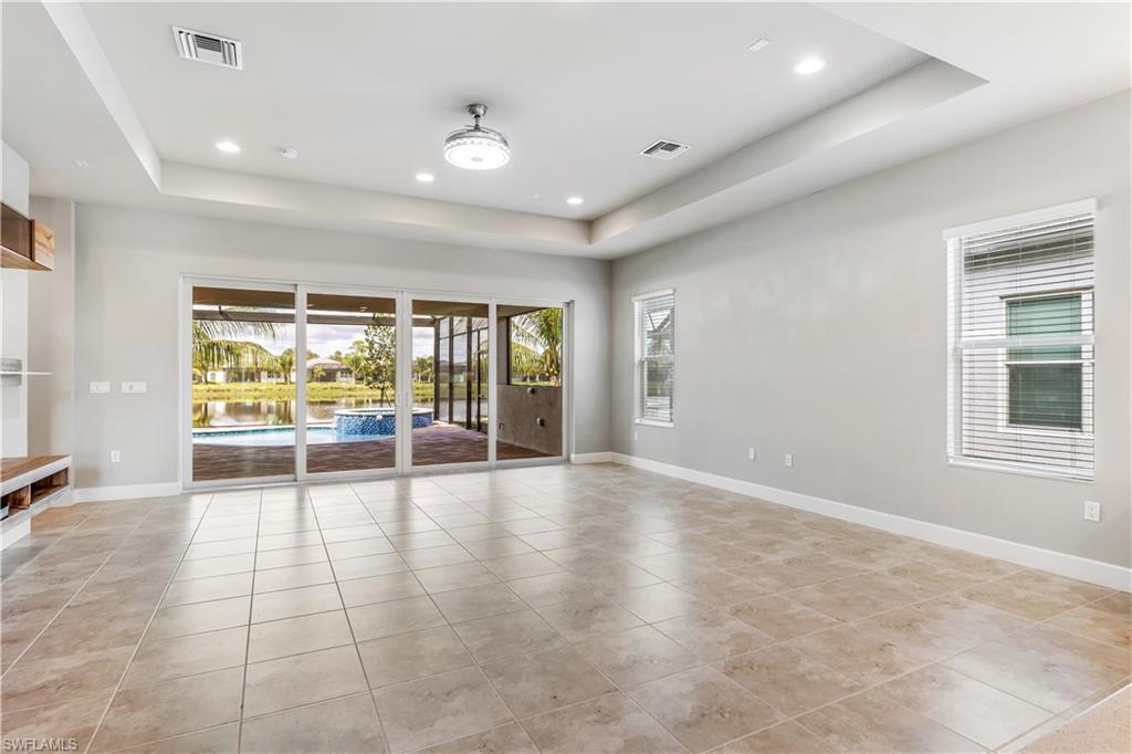 11847 Hydrangea Place Naples, FL 34120 - Photo 8 of 30 an empty room with wooden floor and windows