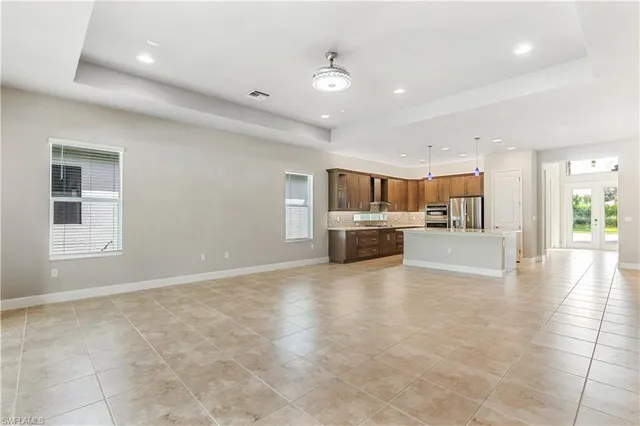 a large kitchen with stainless steel appliances granite countertop a sink and cabinets