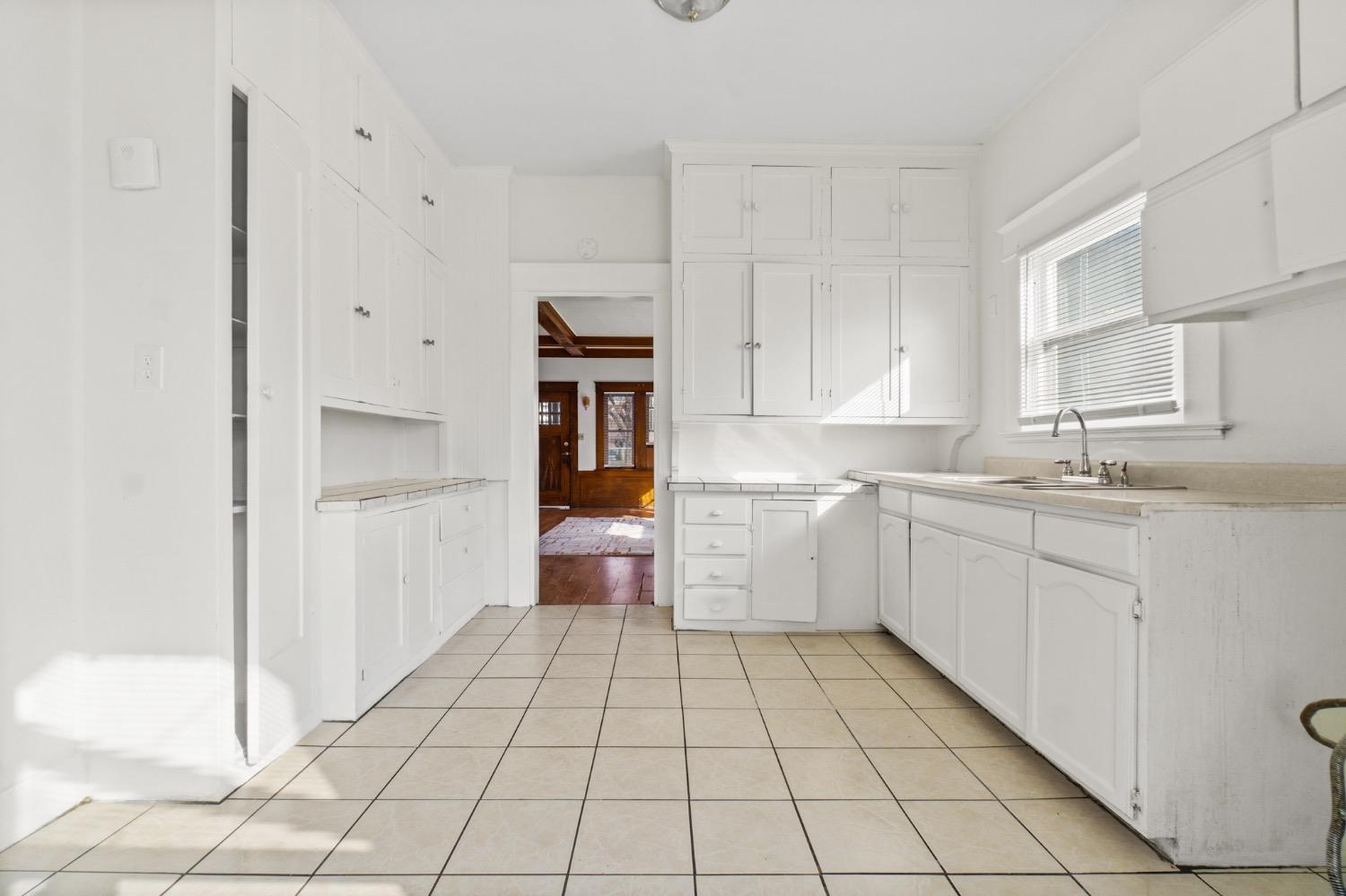 4354 East Kings Canyon Road Fresno, CA 93702 - Photo 15 of 87 a kitchen with a sink a stove and cabinets