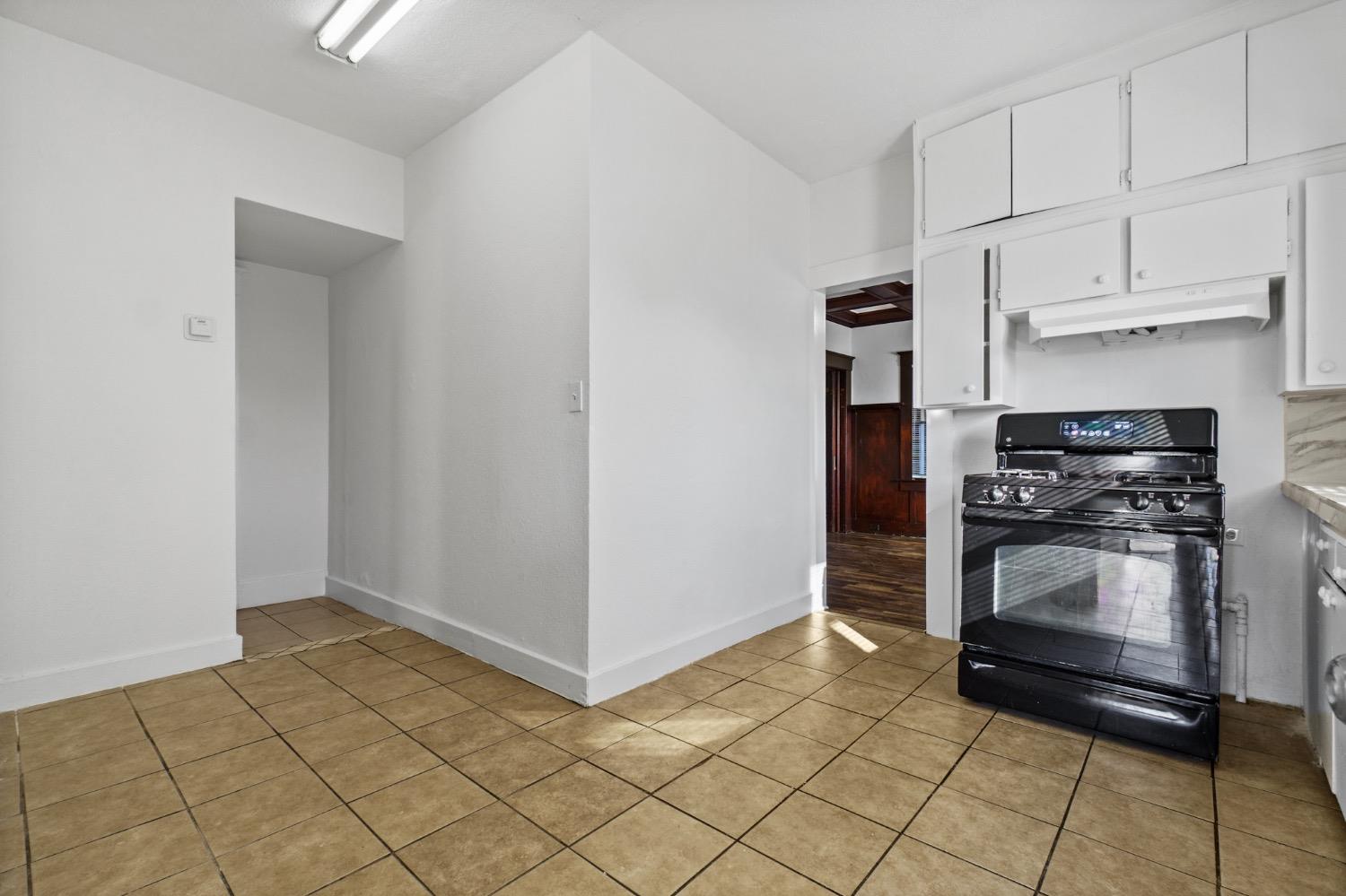 4354 East Kings Canyon Road Fresno, CA 93702 - Photo 44 of 87 a kitchen with white cabinets and appliances