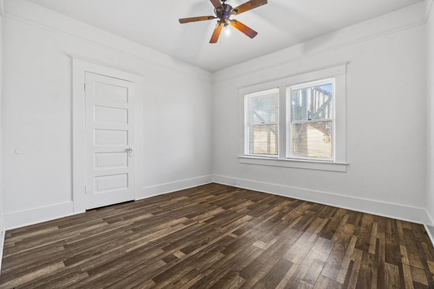 4354 East Kings Canyon Road Fresno, CA 93702 - Photo 48 of 87 a view of an empty room with wooden floor and a window