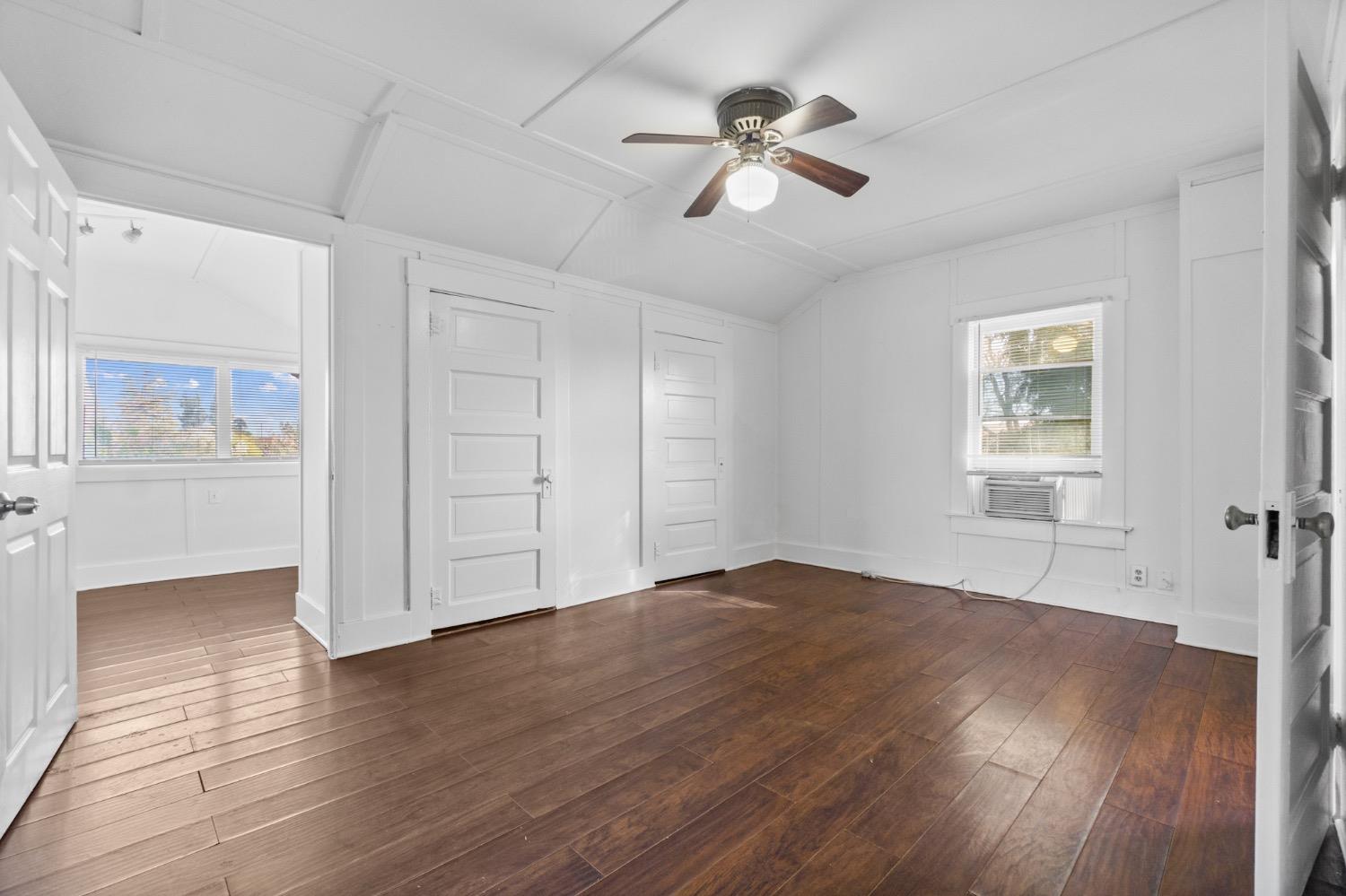 4354 East Kings Canyon Road Fresno, CA 93702 - Photo 65 of 87 a view of an empty room with a window and wooden floor
