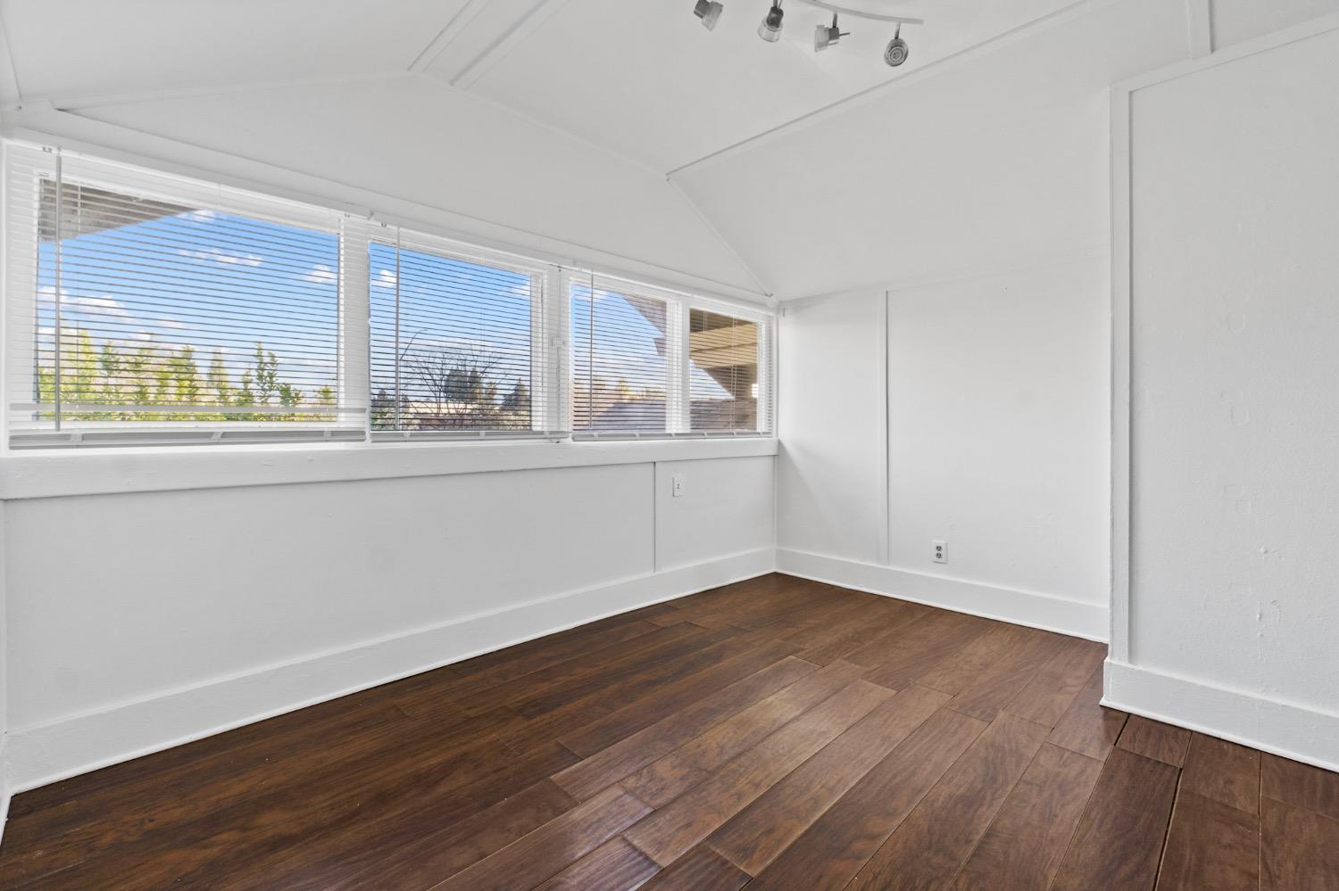 4354 East Kings Canyon Road Fresno, CA 93702 - Photo 69 of 87 a view of a kitchen with wooden floor and electronic appliances