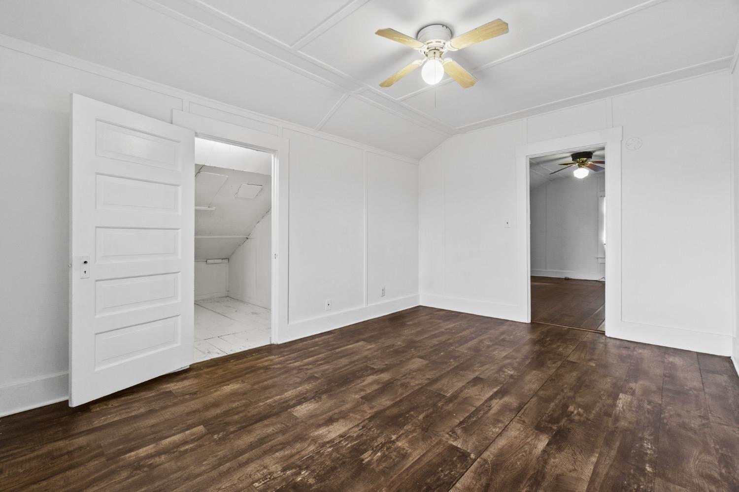 4354 East Kings Canyon Road Fresno, CA 93702 - Photo 72 of 87 an empty room with wooden floor and ceiling fan