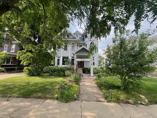 a front view of a house with a garden
