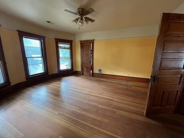 642 West Stephenson Street Freeport, IL 61032 - Photo 2 of 38 a view of an empty room with a window and wooden floor