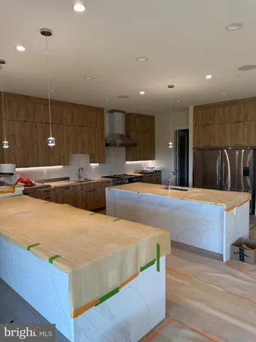 a large kitchen with stainless steel appliances