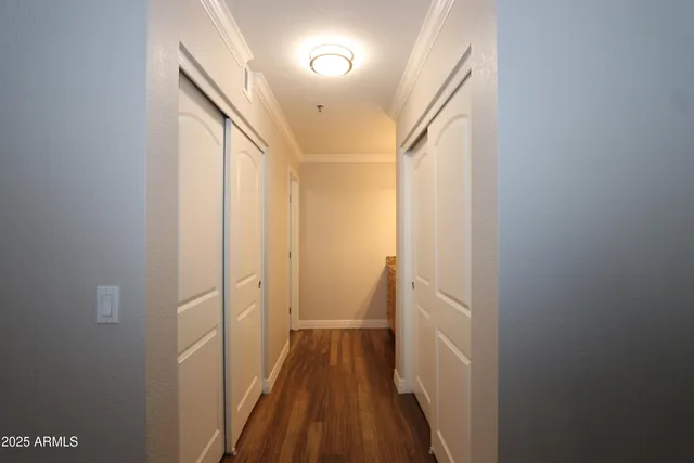 a view of a hallway with wooden floor and staircase