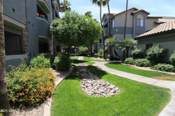 a view of a house with a yard and garden