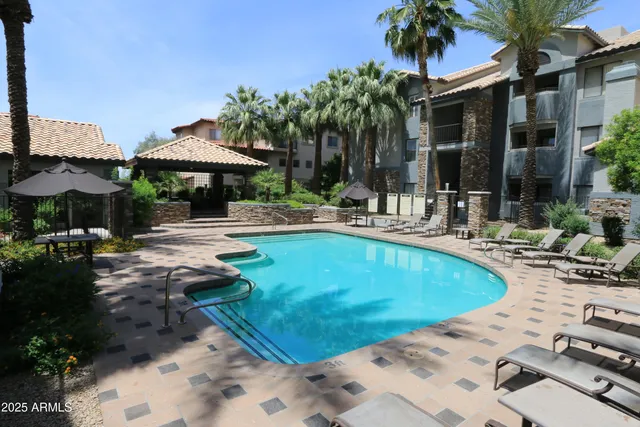 a swimming pool with outdoor seating yard and patio