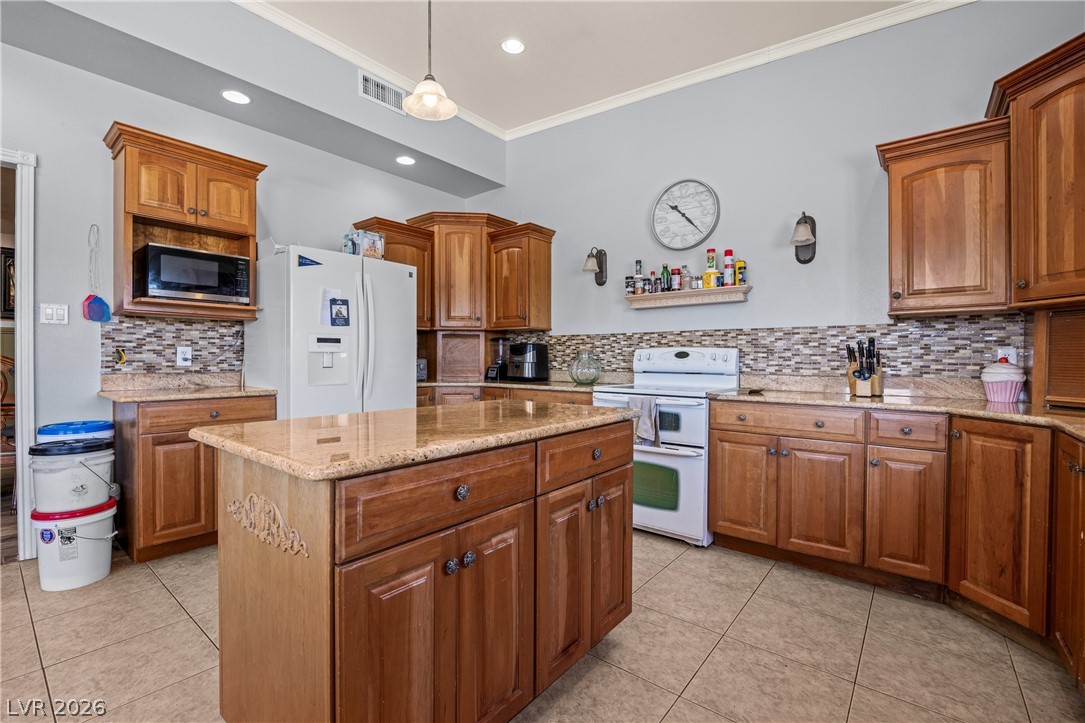 750 Leming Avenue Overton, NV 89040 - Photo 24 of 82 This kitchen offers a practical layout with warm wood cabinetry and durable countertops.
