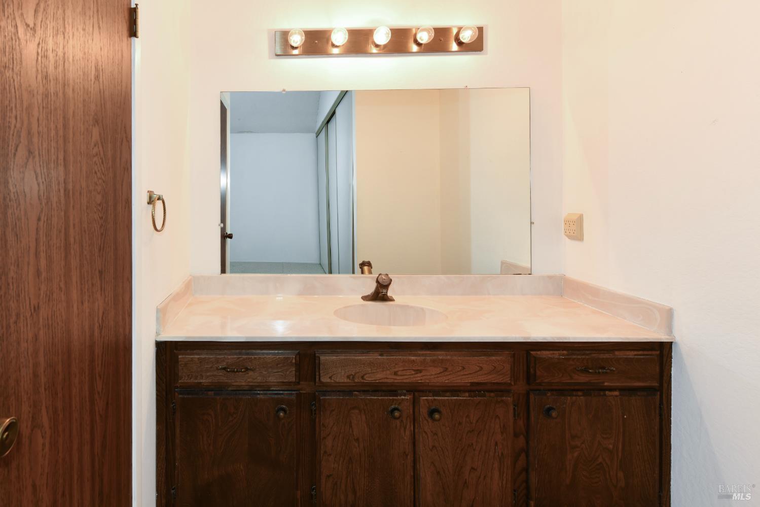 3007 Loma Court Santa Rosa, CA 95405 - Photo 22 of 43 Stand alone vanity sink in Primary bedroom with linen closet.