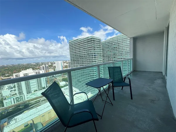 a view of balcony with furniture