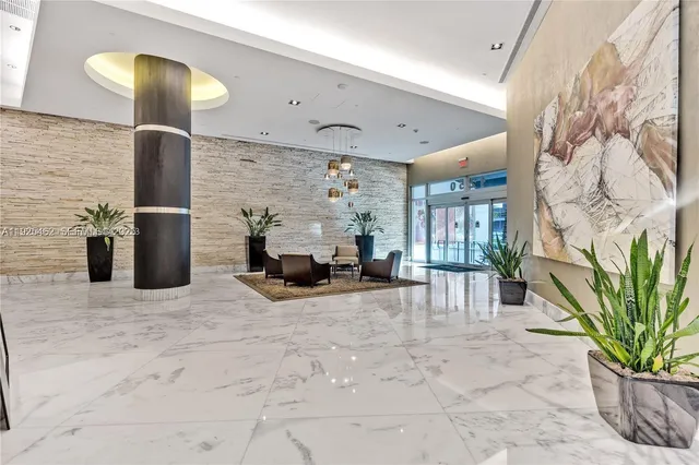 a view of a livingroom with furniture and a potted plant
