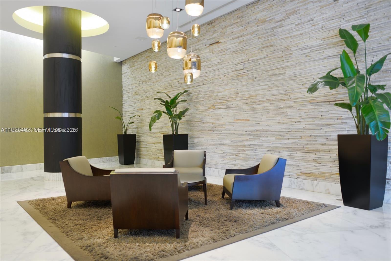 1250 South Miami Avenue, Unit 2805 Miami, FL 33130 - Photo 27 of 30 a living room with furniture a potted plant and a lamp