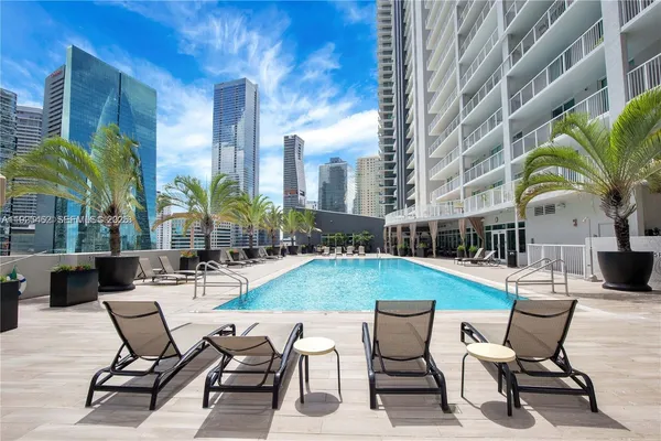 a swimming pool with outdoor seating and yard