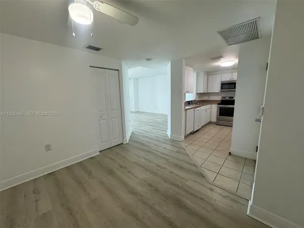 a kitchen with granite countertop a stove a sink and a refrigerator