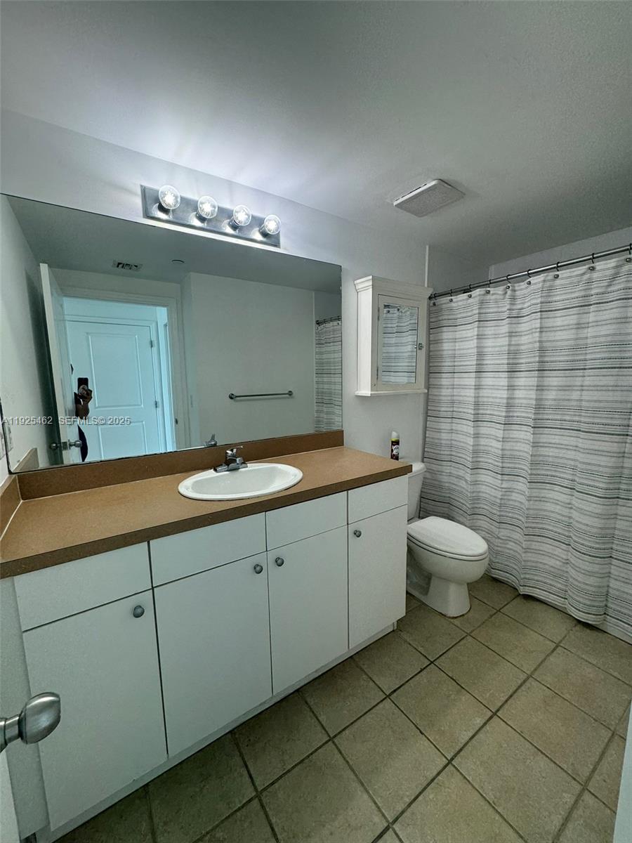 1250 South Miami Avenue, Unit 2805 Miami, FL 33130 - Photo 10 of 30 a bathroom with a double vanity sink mirror and toilet