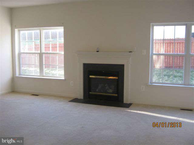3406 Kidder Road Clinton, MD 20735 - Photo 12 of 26 an empty room with windows and fireplace