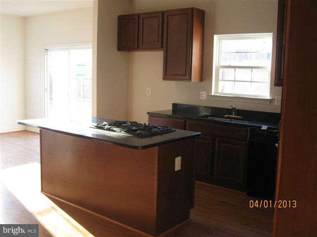 3406 Kidder Road Clinton, MD 20735 - Photo 14 of 26 a kitchen with granite countertop a sink cabinets and a window