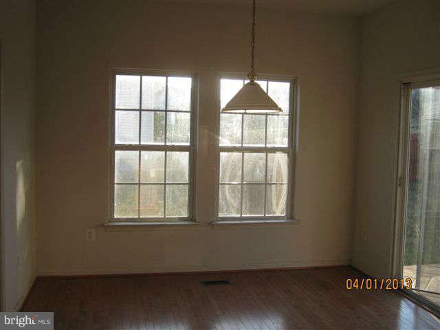 3406 Kidder Road Clinton, MD 20735 - Photo 15 of 26 an empty room with wooden floor and windows