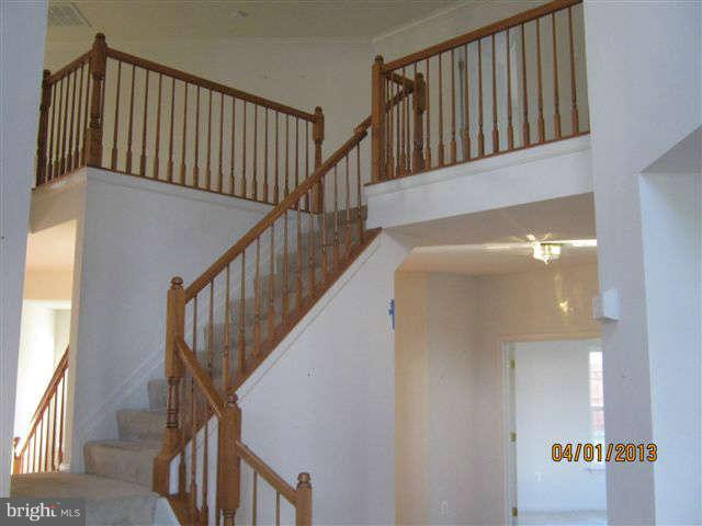 3406 Kidder Road Clinton, MD 20735 - Photo 16 of 26 a view of staircase with railing and white walls
