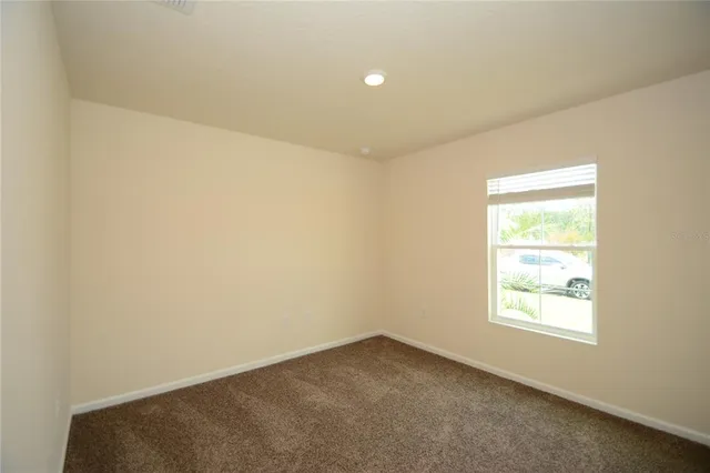 a bathroom with a granite countertop toilet and sink