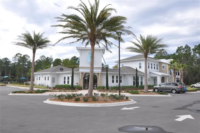 a view of a swimming pool with a bench and trees in the background