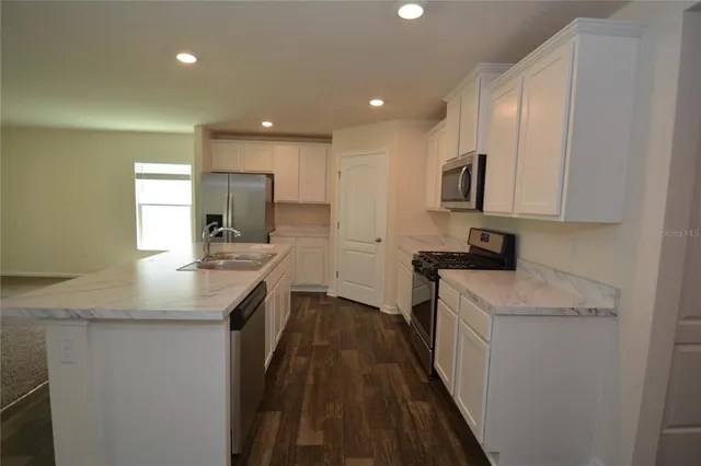 a kitchen with a sink stove and cabinets