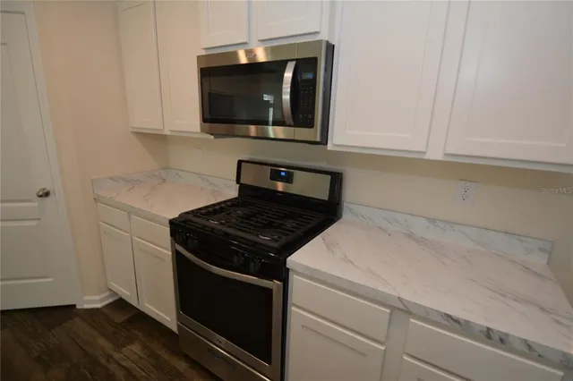 a kitchen with a stove and a microwave