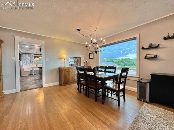 a view of a dining room with furniture window and wooden floor