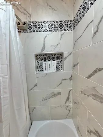 a bathroom with a bathtub and shower