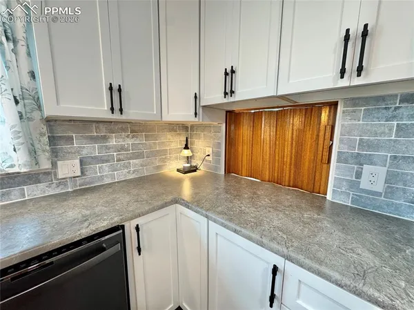 a kitchen with stainless steel appliances granite countertop wooden cabinets a sink and dishwasher
