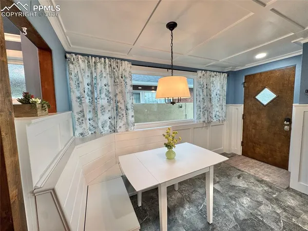 a view of a room with a sink wooden floor and a chandelier