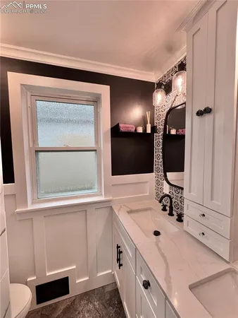 a bathroom with a double vanity sink and mirror