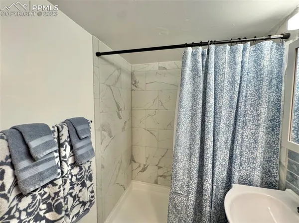 a bathroom with a toilet and a shower curtain
