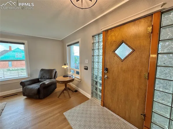 a living room with furniture wooden floor and window