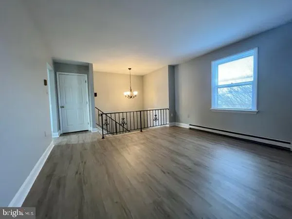 a view of a room with wooden floor windows and a ceiling fan