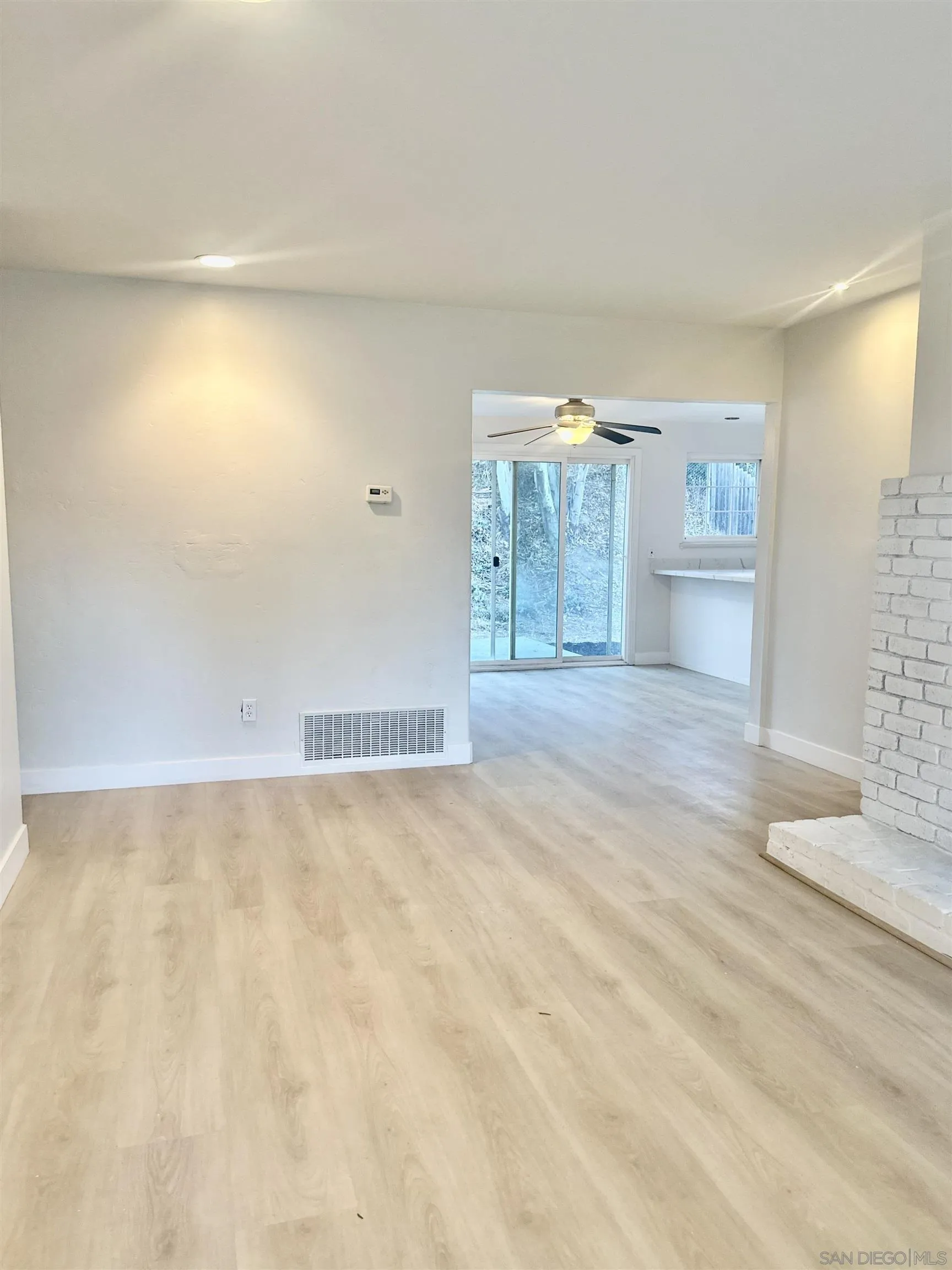 13534 Mountainside Drive Poway, CA 92064 - Photo 3 of 9 a view of a livingroom with an empty space and wooden floor