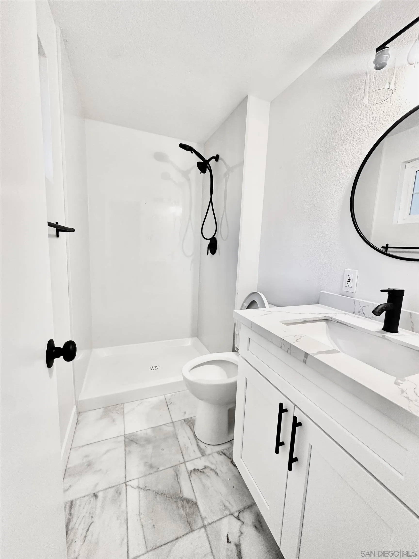 13534 Mountainside Drive Poway, CA 92064 - Photo 4 of 9 a bathroom with a granite countertop sink a toilet and a mirror