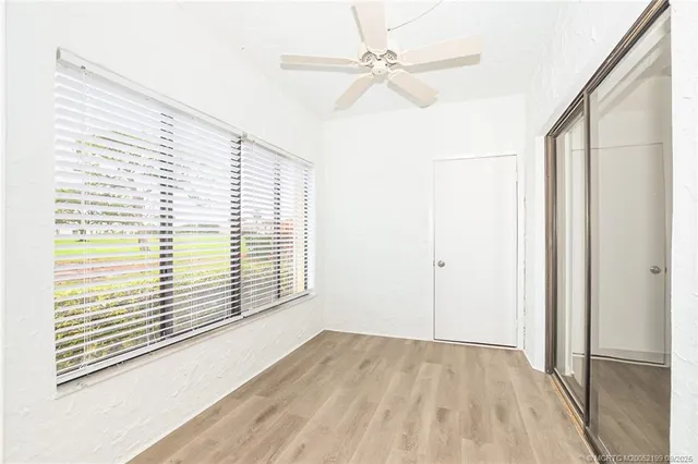 a view of a livingroom with a ceiling fan and window