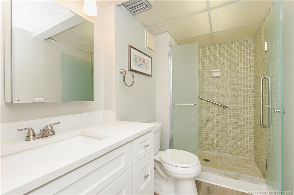 5373 Southeast Miles Grant Road, Unit C102 Stuart, FL 34997 - Photo 15 of 21 a bathroom with a sink toilet and shower