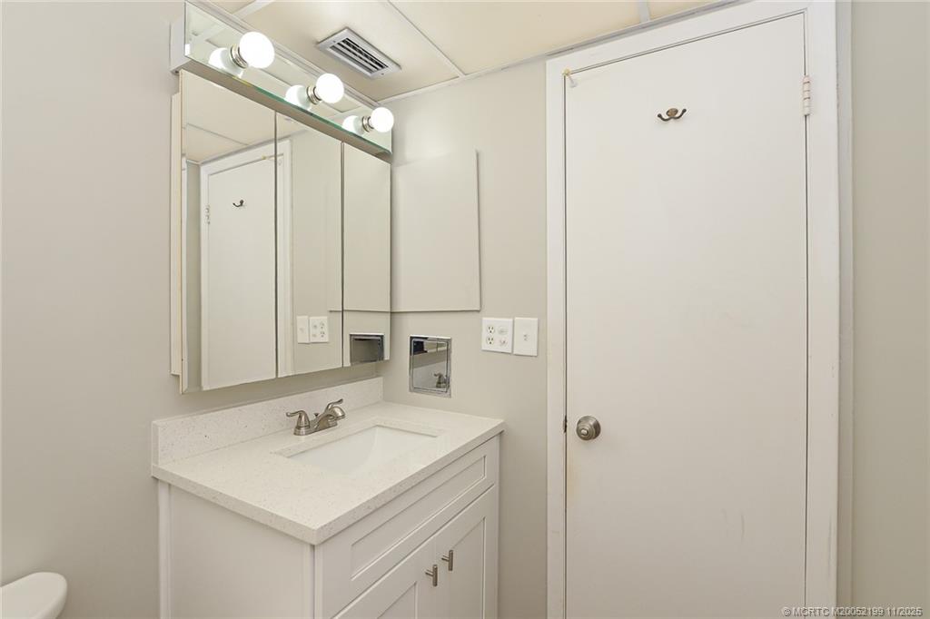 5373 Southeast Miles Grant Road, Unit C102 Stuart, FL 34997 - Photo 19 of 21 a bathroom with a sink and a mirror