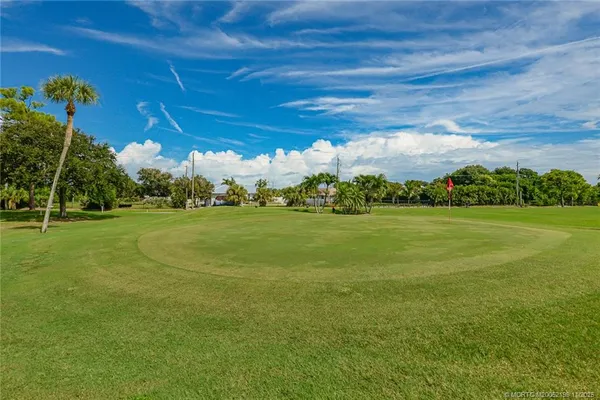 a view of a golf course with a big yard