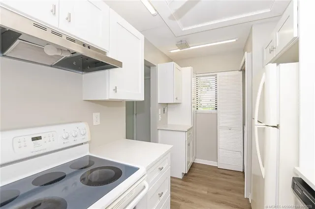 a kitchen with a sink a stove and refrigerator