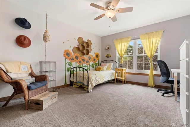 a bedroom with a bed chair and a large window